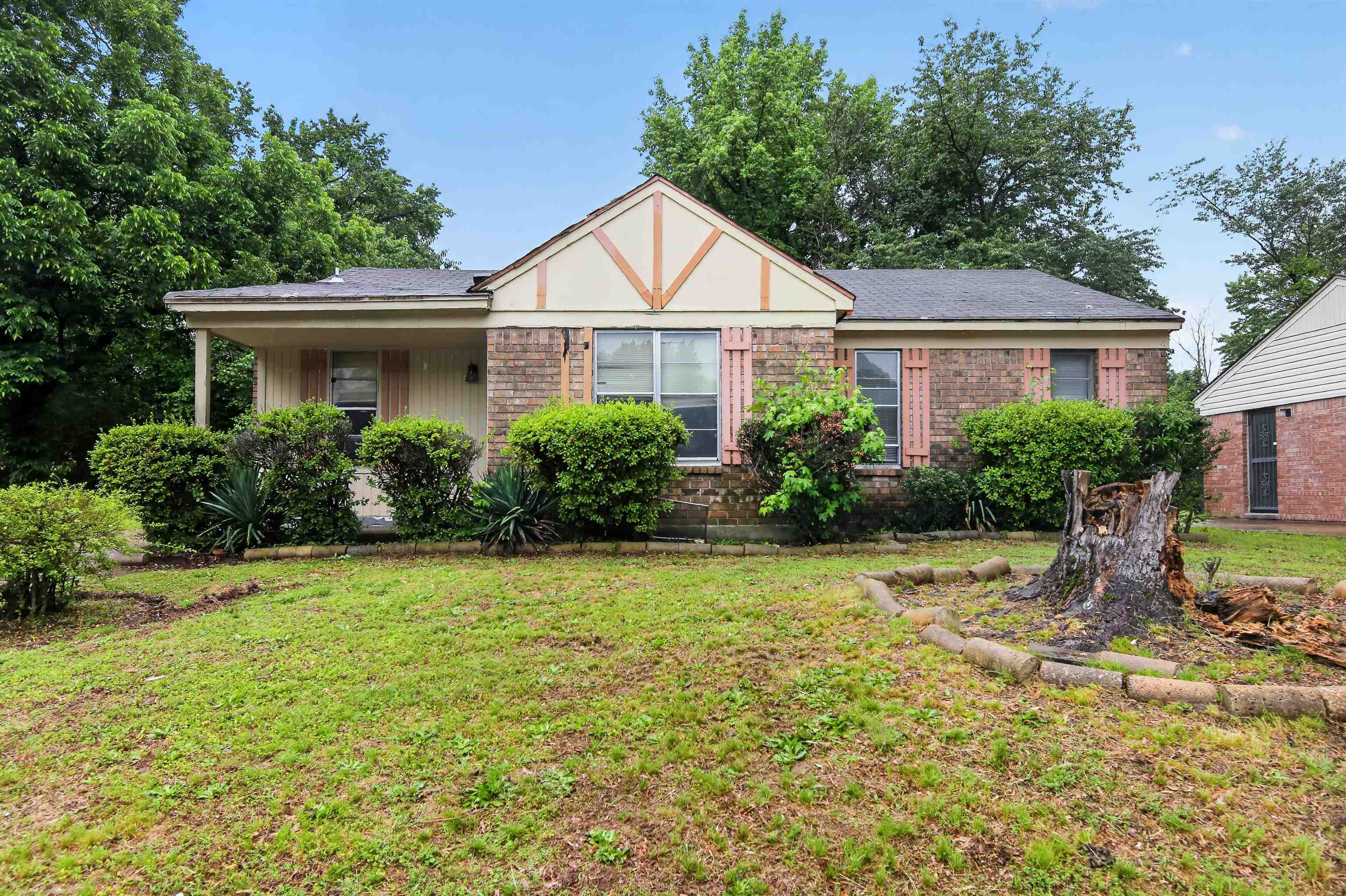 3451 Birdsong Ferry Road Memphis, TN 38118 - Photo 1 of 27 Exterior brick facade with decorative shutters, covered front porch, and mature landscaping