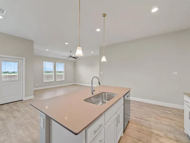 a kitchen with a sink and chandelier
