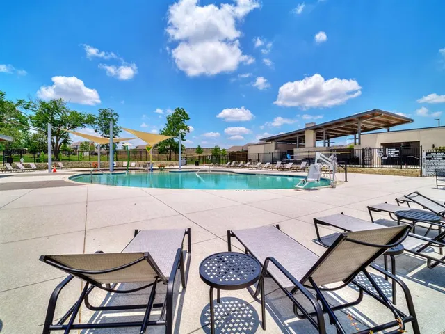 a view of a patio with table and chairs and potted plants