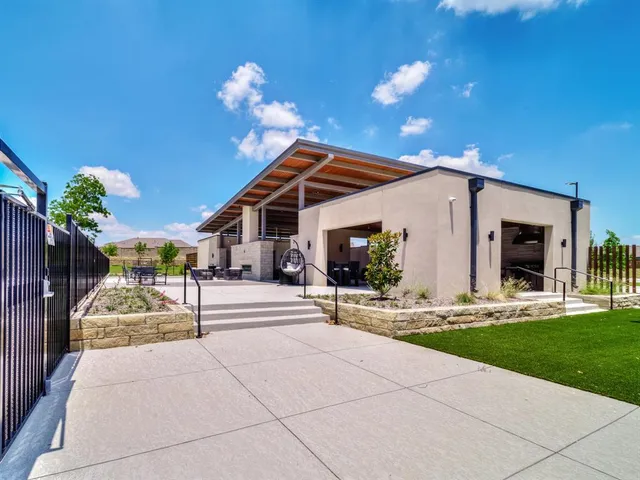 a view of a house with backyard porch and sitting area