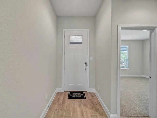 a view of a hallway with wooden floor