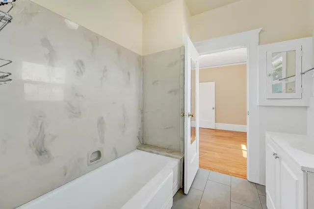 a kitchen with wooden floors and wooden cabinets