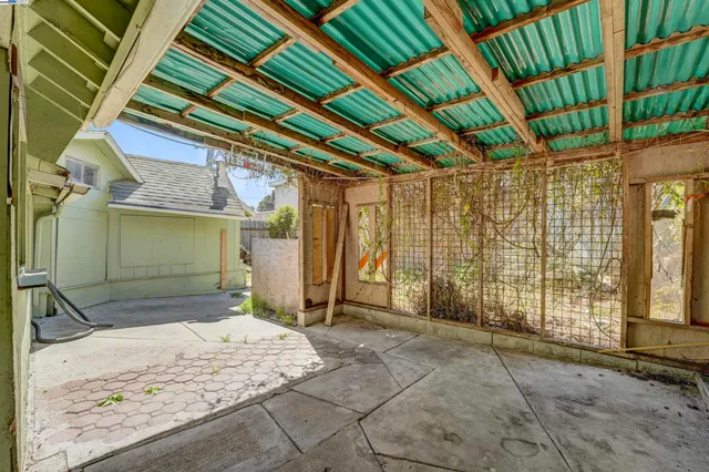 a view of a kitchen with refrigerator and white cabinets