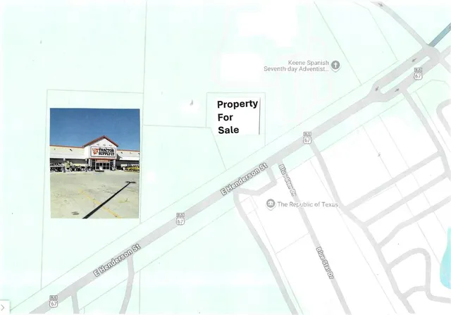 a kitchen with a sink and a painting on the wall