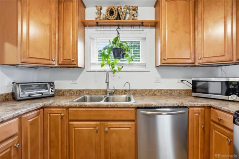 a kitchen with stainless steel appliances granite countertop a sink stove and cabinets