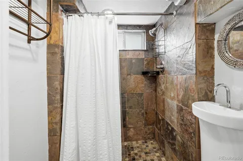 a bathroom with a shower and a sink
