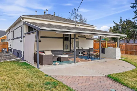 a view of a patio with table and chairs and potted plants