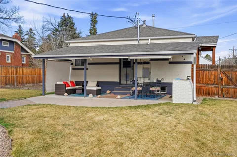 a view of a house with backyard and a patio