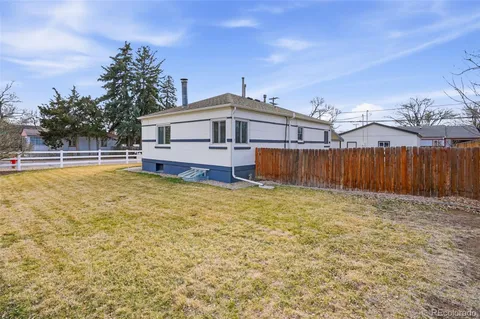 a view of a house with a wooden fence