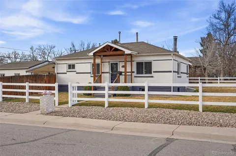 a view of a house with a wooden fence