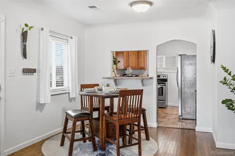 a view of a dining room with furniture and wooden floor