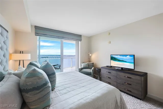 a bedroom with a bed and a flat screen tv