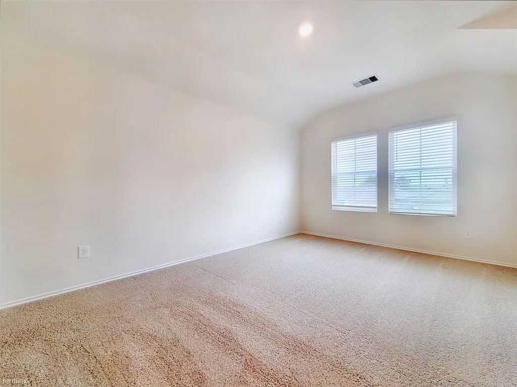 419 Sickle Loop Kyle, TX 78640 - Photo 14 of 35 A quiet space with soft carpeting and ample natural light from two windows.