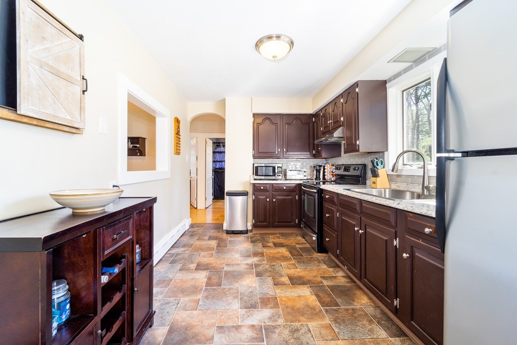 30 County Road Freetown, MA 02717 - Photo 15 of 35 a large kitchen with stainless steel appliances granite countertop a stove sink and cabinets