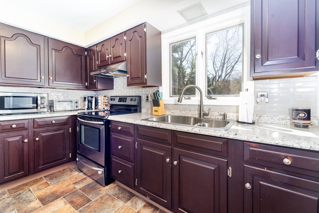30 County Road Freetown, MA 02717 - Photo 16 of 35 a kitchen with stainless steel appliances granite countertop a sink dishwasher stove and cabinets