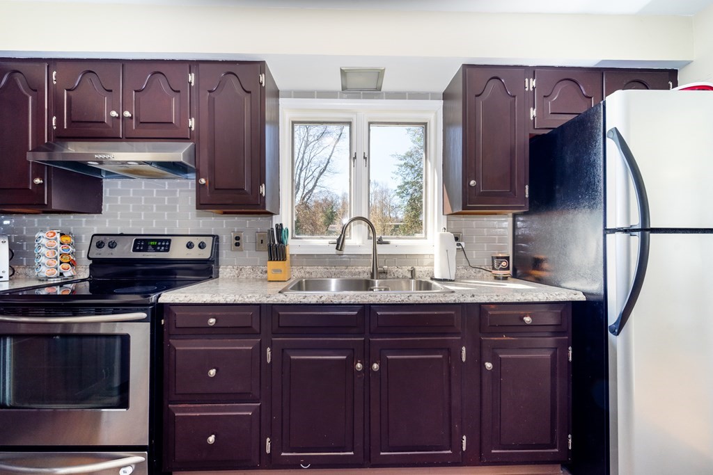 30 County Road Freetown, MA 02717 - Photo 18 of 35 a kitchen with granite countertop wooden cabinets and a sink