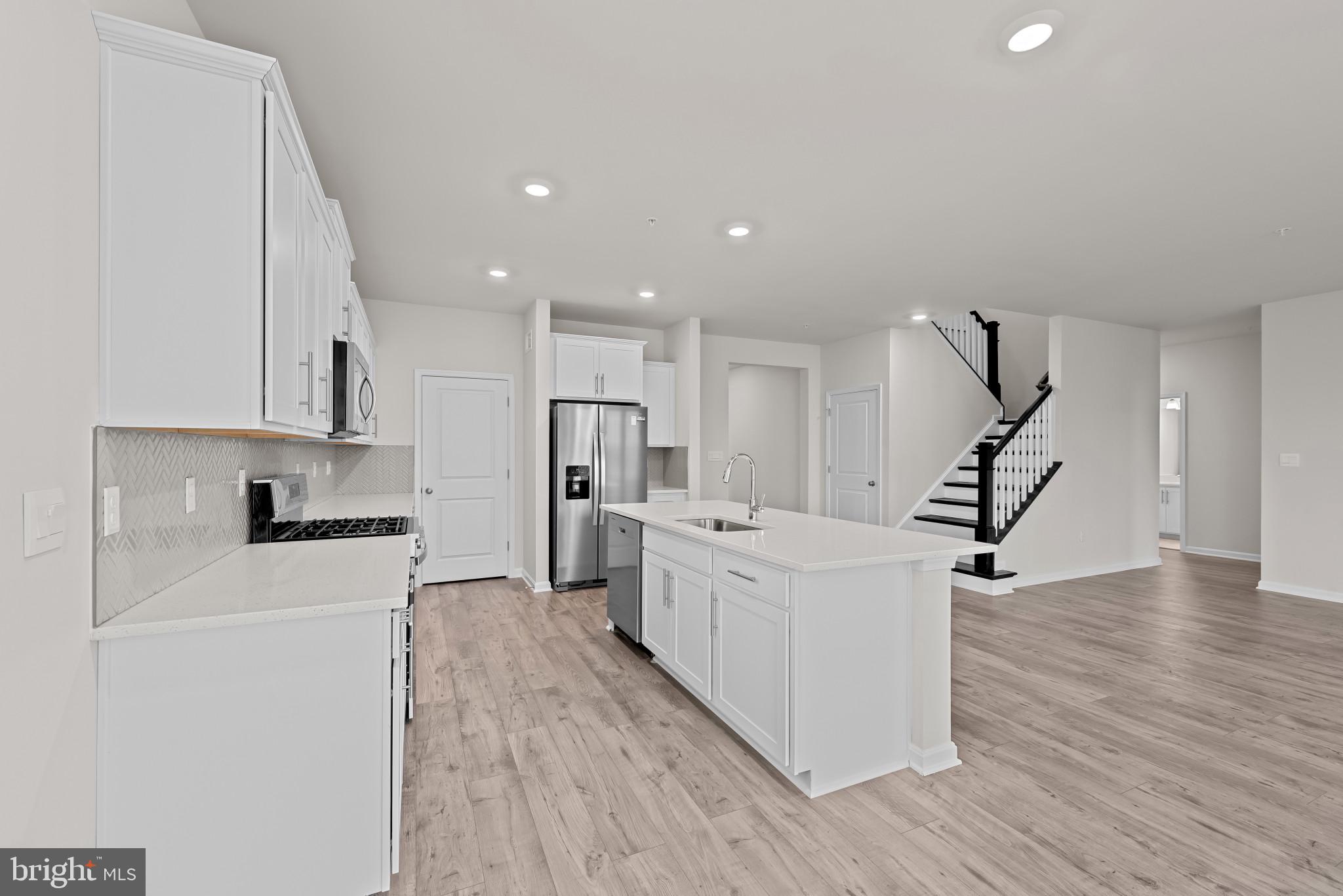 8103 Cypress Pt Drive Rosedale, MD 21237 - Photo 12 of 45 a kitchen with white cabinets and stainless steel appliances