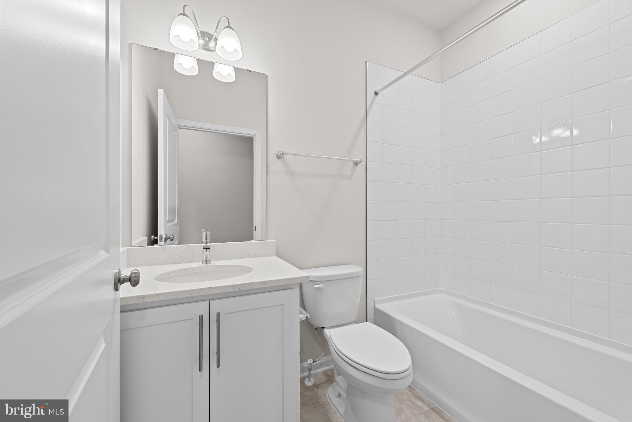 8103 Cypress Pt Drive Rosedale, MD 21237 - Photo 16 of 45 a bathroom with a sink a toilet and shower