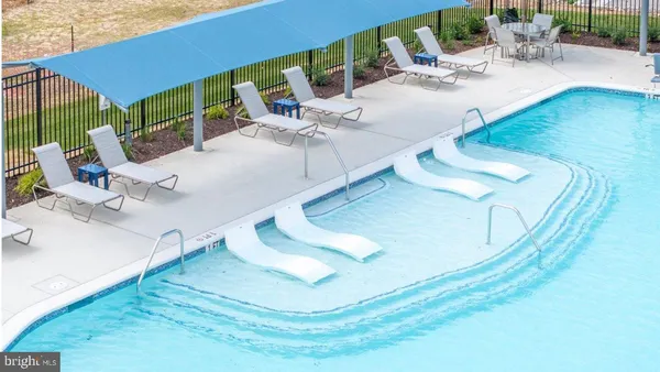 a view of swimming pool with outdoor seating and living room