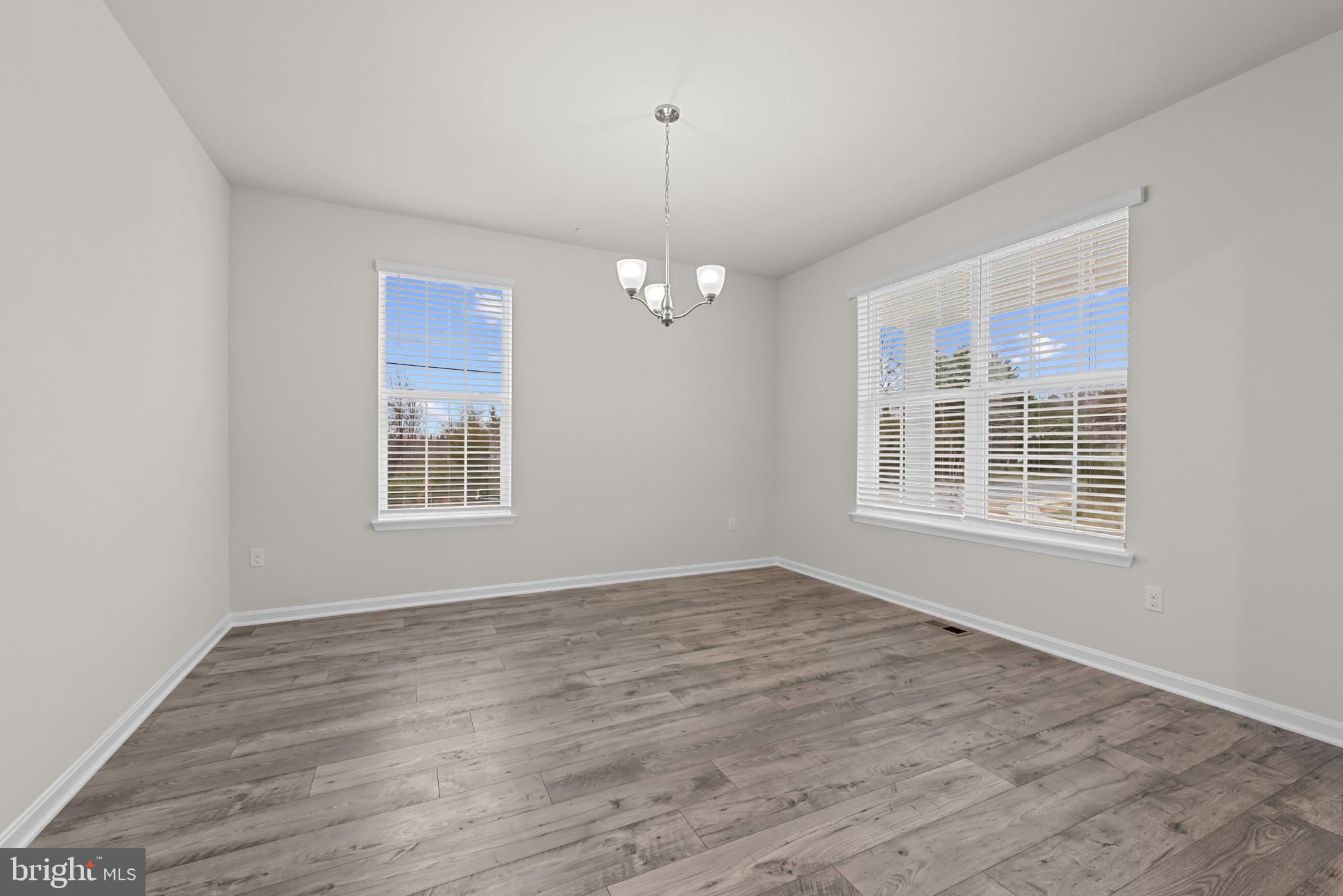 8103 Cypress Pt Drive Rosedale, MD 21237 - Photo 4 of 45 a view of an empty room with wooden floor and a window