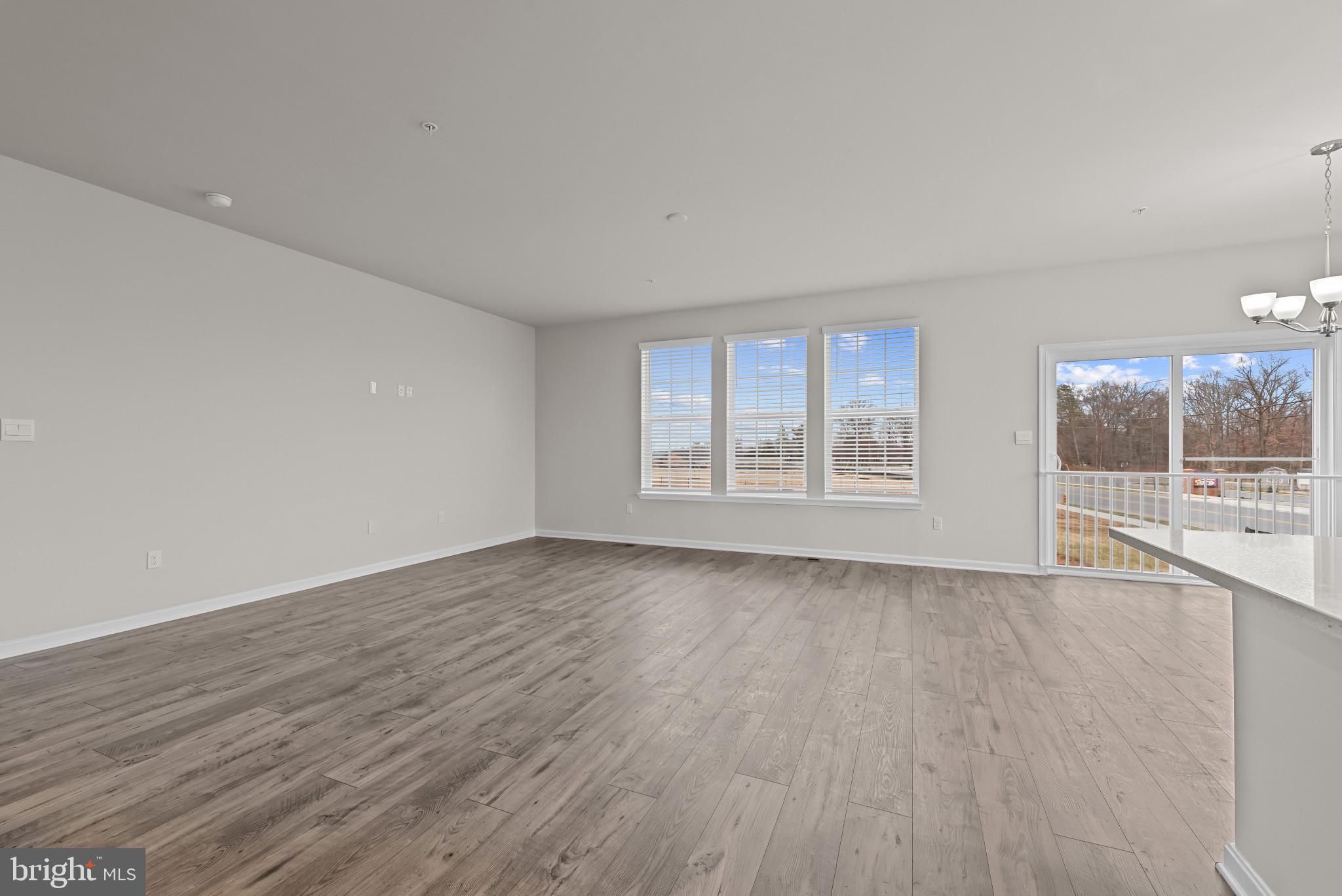 8103 Cypress Pt Drive Rosedale, MD 21237 - Photo 6 of 45 a view of an empty room with wooden floor and a window