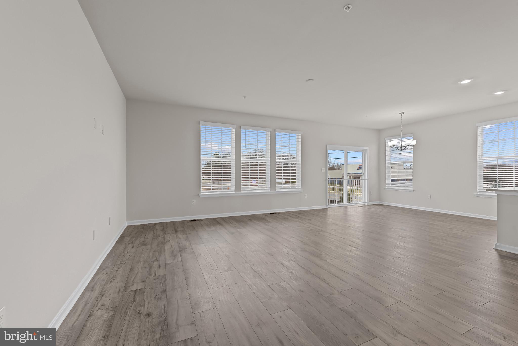 8103 Cypress Pt Drive Rosedale, MD 21237 - Photo 7 of 45 an empty room with wooden floor and windows