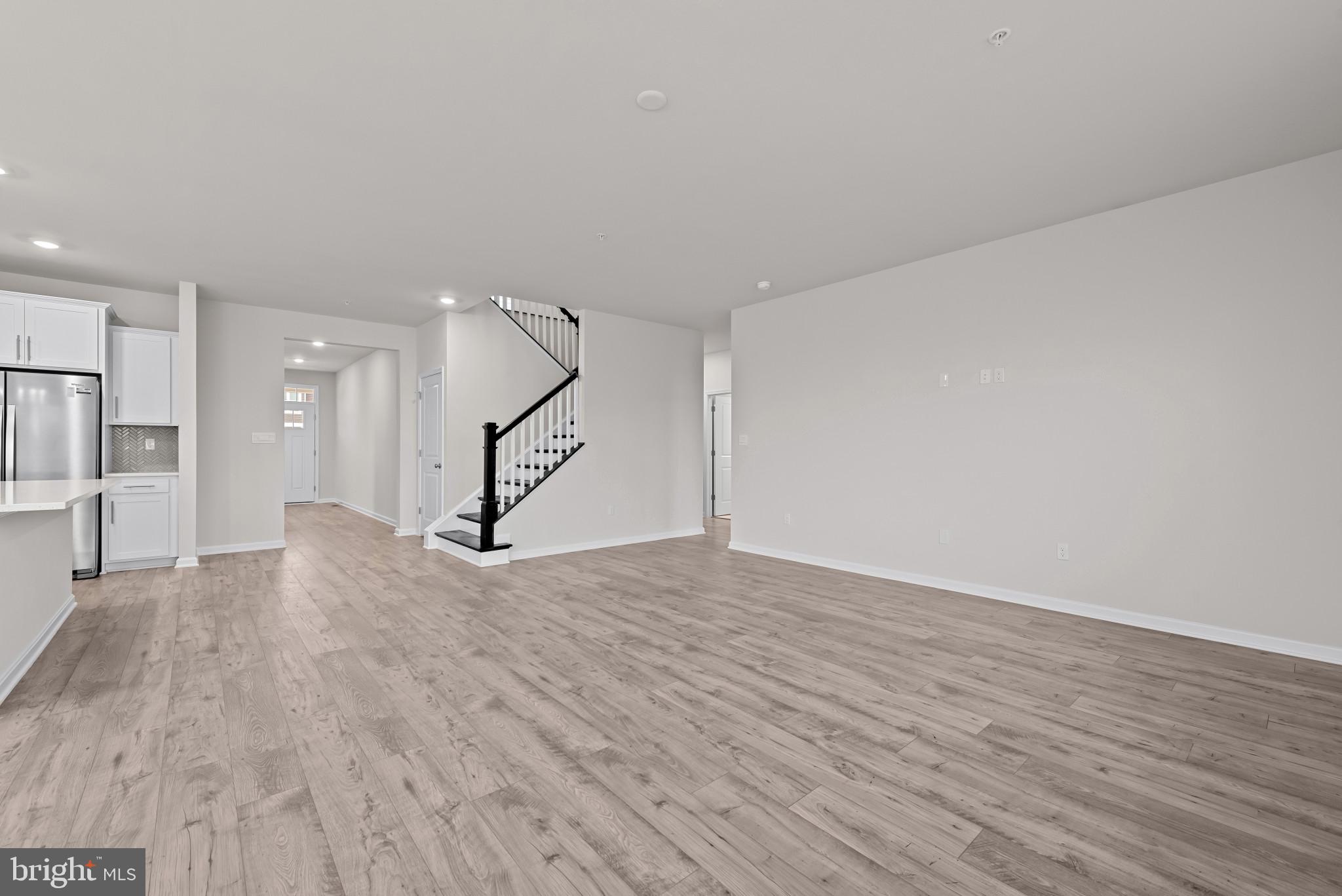 8103 Cypress Pt Drive Rosedale, MD 21237 - Photo 8 of 45 a view of an empty room with wooden floor and stairs