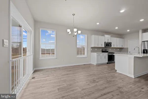 a view of a kitchen with microwave and cabinets