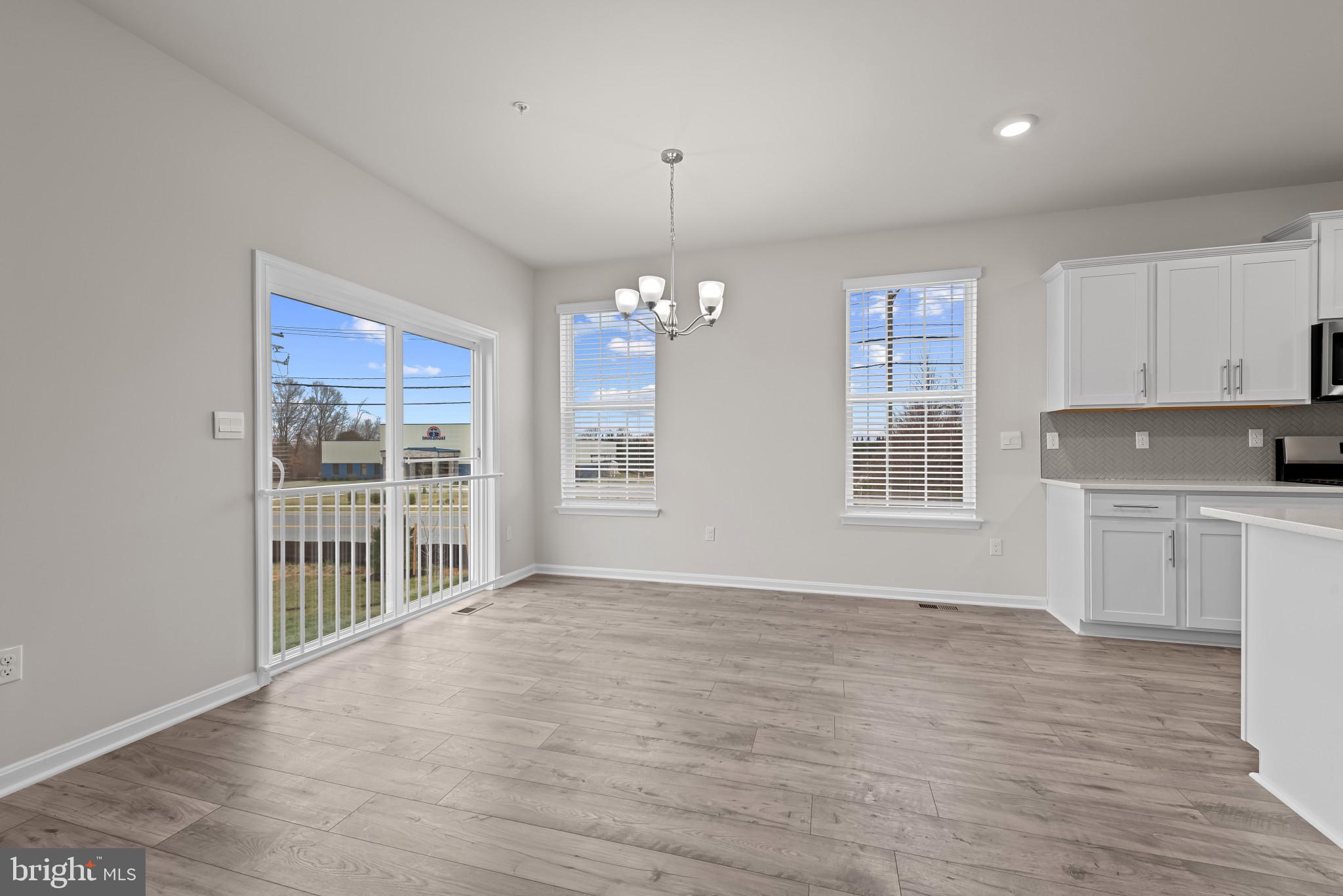8103 Cypress Pt Drive Rosedale, MD 21237 - Photo 10 of 45 a view of an empty room with window and wooden floor