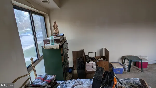 a living room with furniture and a mirror