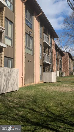 a view of a big room with a big yard and large trees