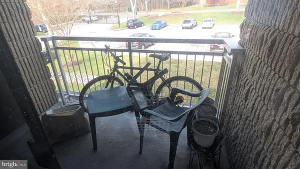 a view of a chairs and table in the balcony