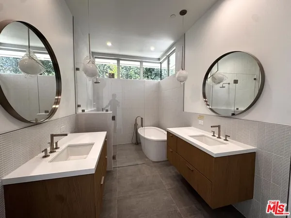 a bathroom with a sink mirror and toilet