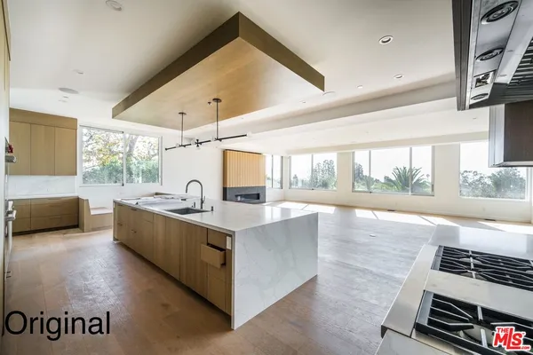 a open kitchen with kitchen island granite countertop a stove and a view of living room