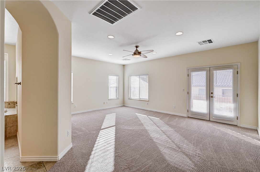 6761 Clay TABLET Street Las Vegas, NV 89149 - Photo 35 of 73 Plentiful natural light streams across the carpeted floors through elegant French doors.
