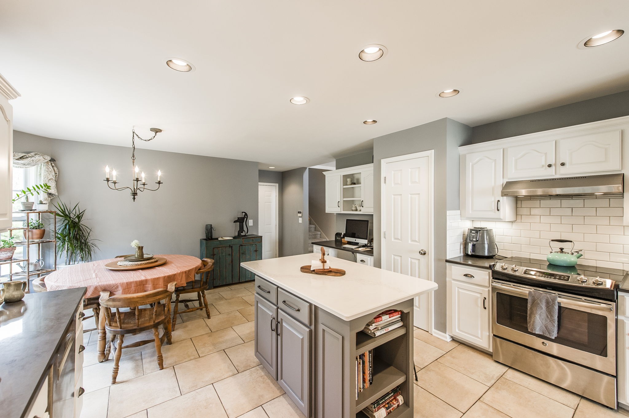 317 Cherry Lane White House, TN 37188 - Photo 41 of 70 a kitchen with a stove a sink a kitchen island with chairs and wooden floor