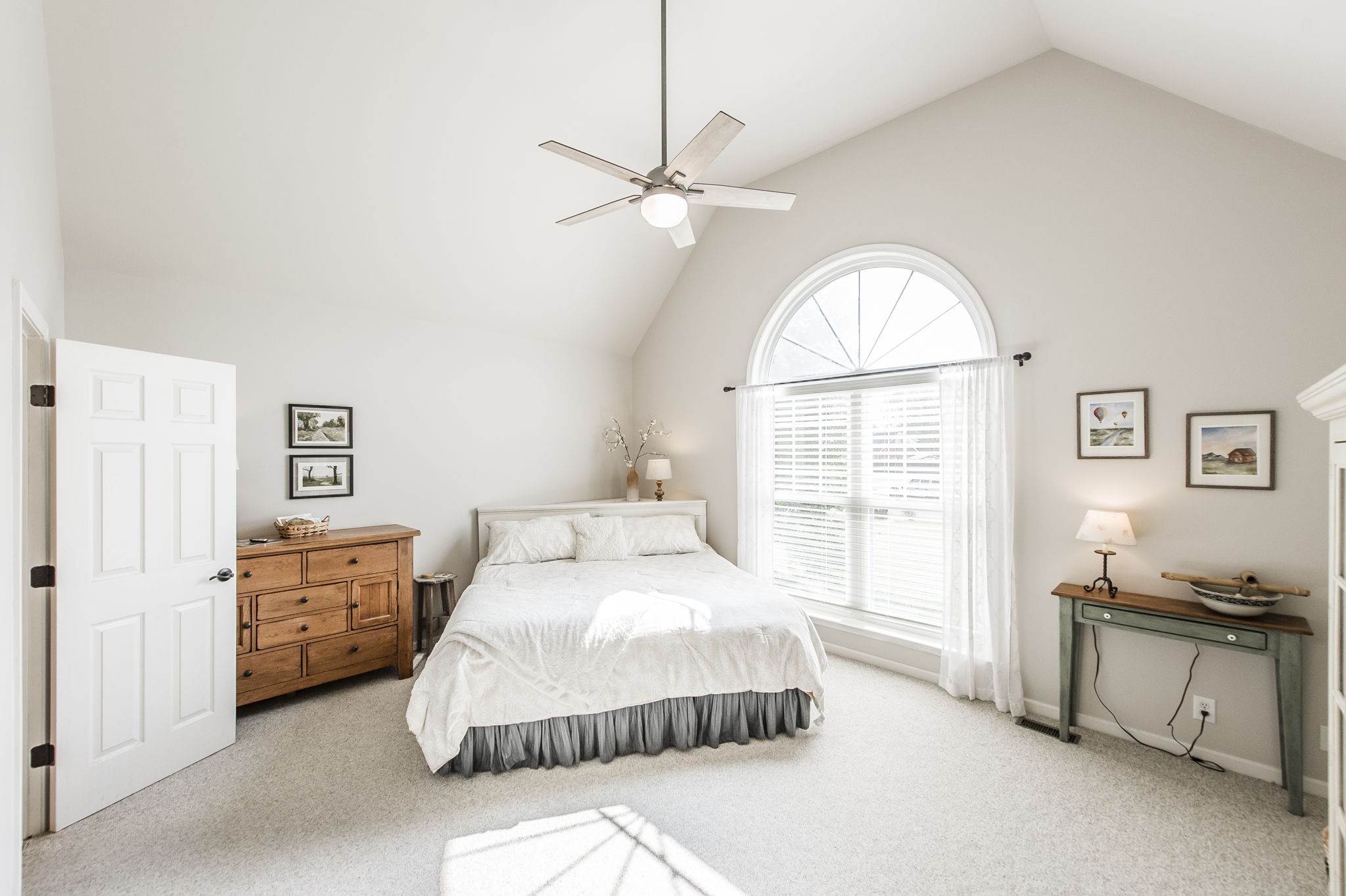 317 Cherry Lane White House, TN 37188 - Photo 46 of 70 a spacious bedroom with a bed and a chandelier