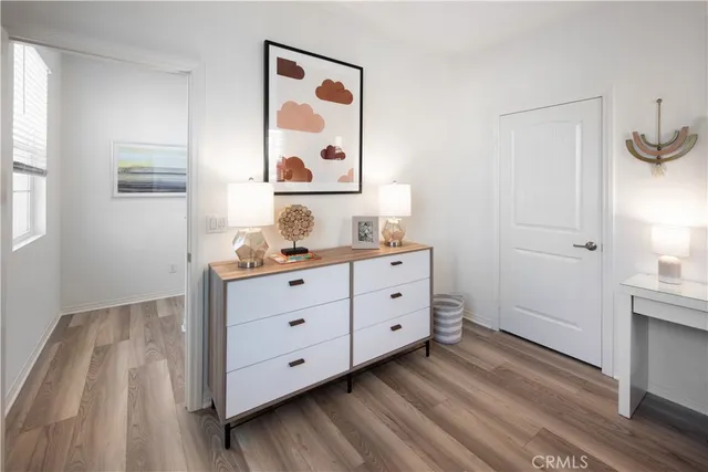 a room with a dresser and a window