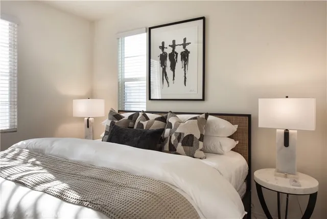 a bedroom with a bed and a painting on the wall