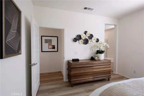 a bedroom with bed and wooden floor