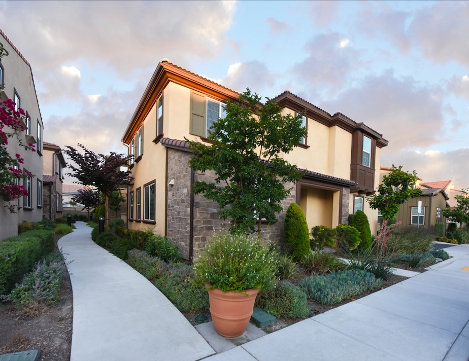 7075 Montecito Lane Eastvale, CA 92880 - Photo 2 of 26 a front view of a house with a garden