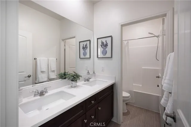 a bathroom with a double vanity sink mirror double and tub