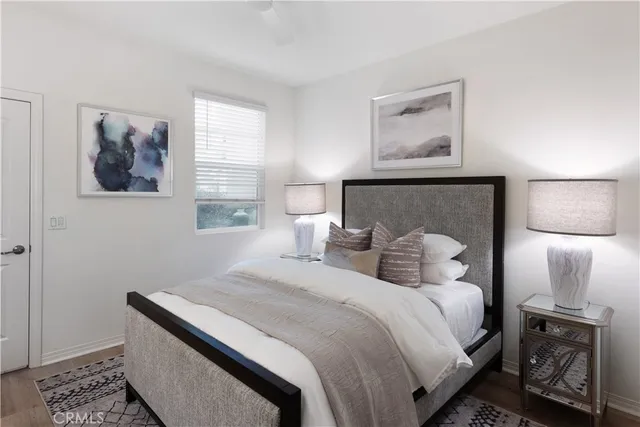 a bedroom with a bed and a lamp with window