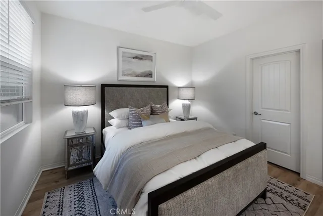 a bedroom with a bed and a lamp