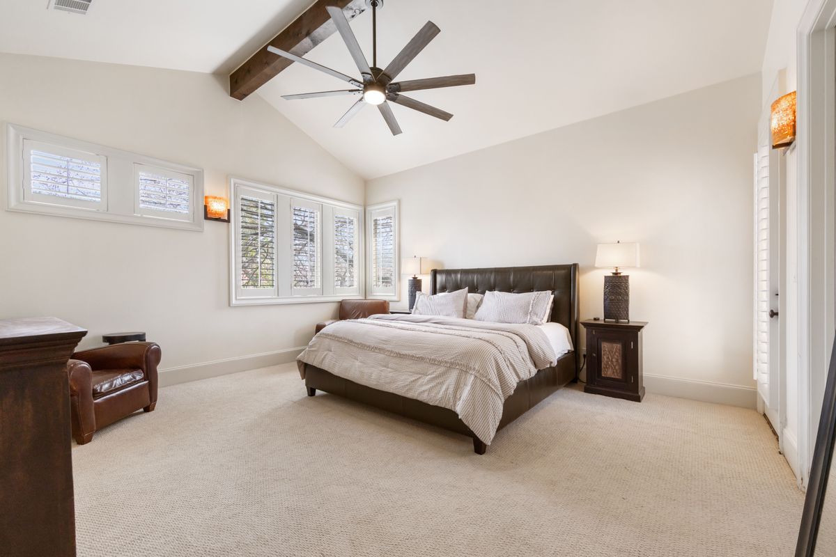 2002 Kinney Avenue, Unit A Austin, TX 78704 - Photo 13 of 26 a bedroom with a bed and a chandelier