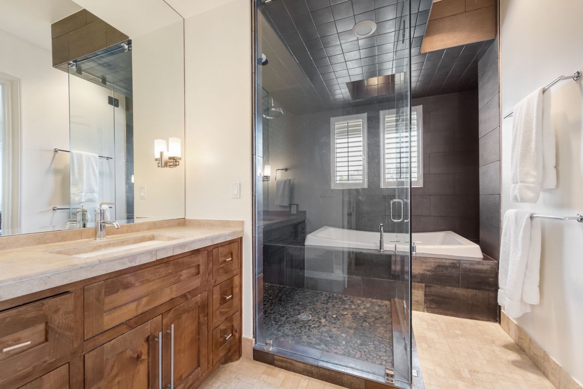 2002 Kinney Avenue, Unit A Austin, TX 78704 - Photo 15 of 26 a spacious bathroom with a granite countertop sink a mirror and a shower