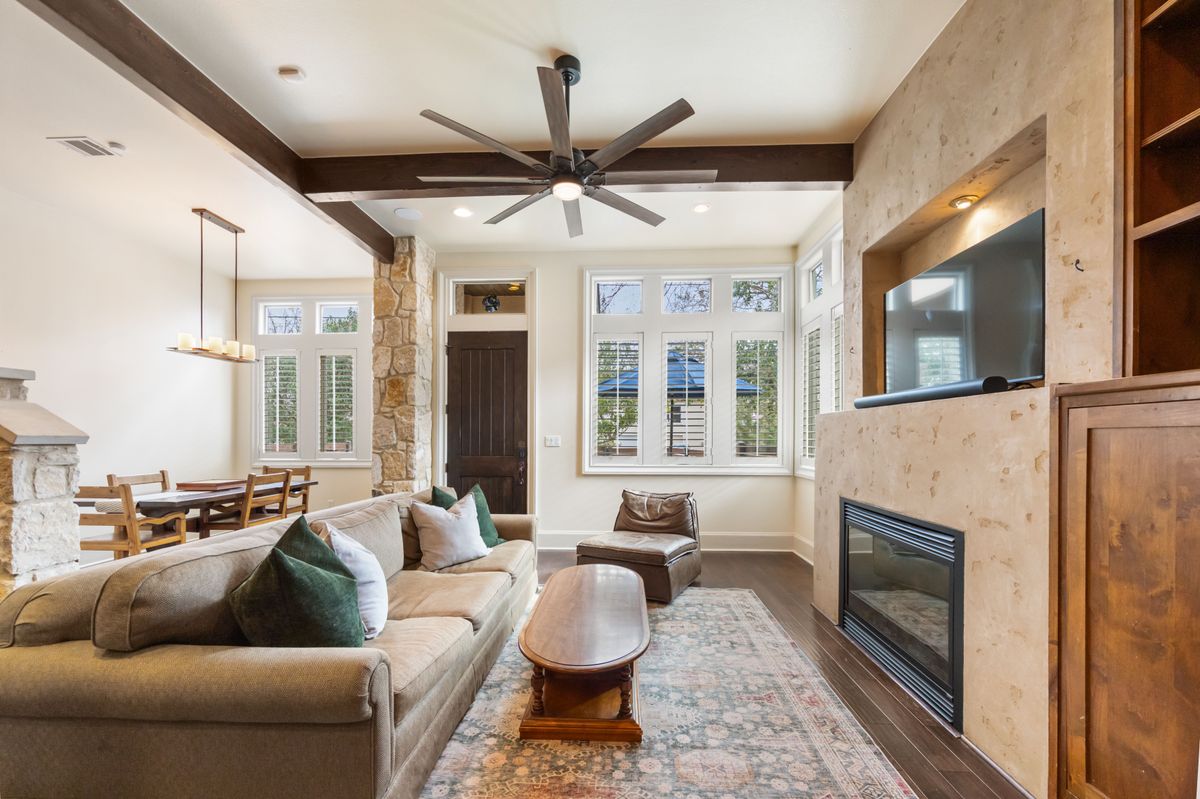 2002 Kinney Avenue, Unit A Austin, TX 78704 - Photo 5 of 26 a living room with furniture a fireplace and a large window
