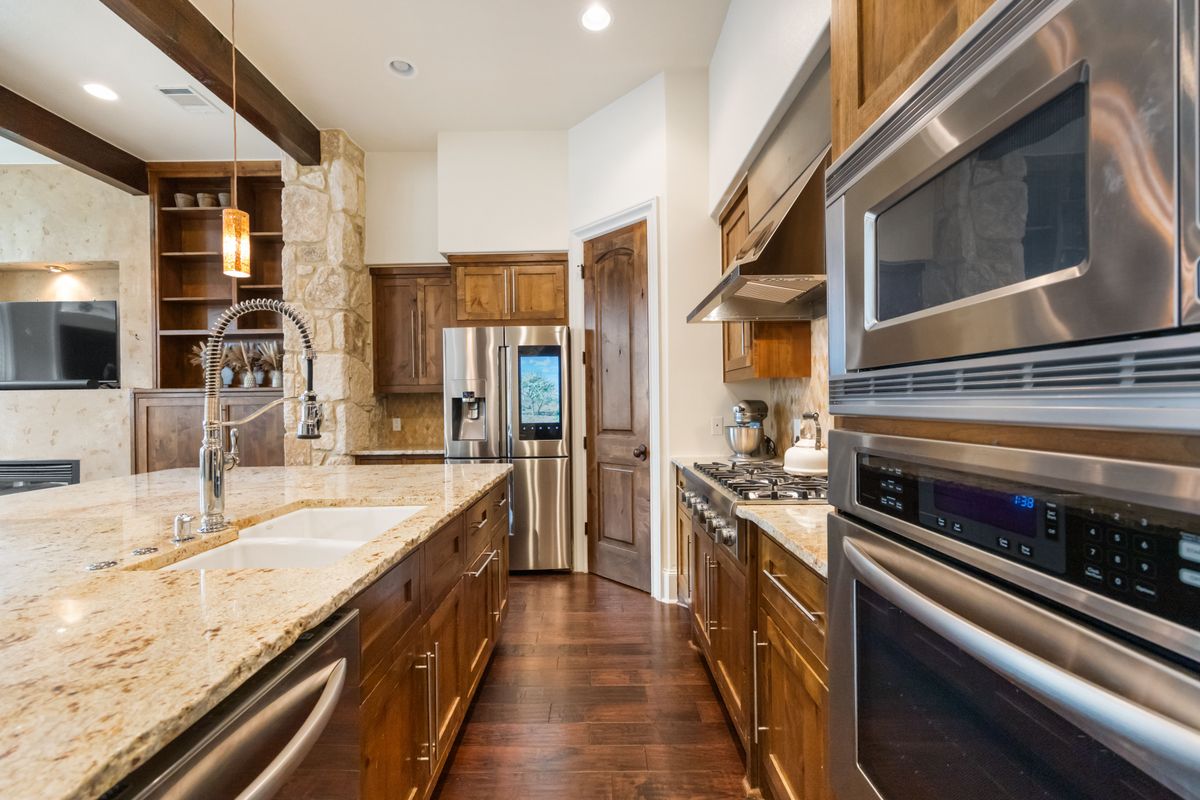 2002 Kinney Avenue, Unit A Austin, TX 78704 - Photo 9 of 26 a kitchen with stainless steel appliances granite countertop a stove and a sink