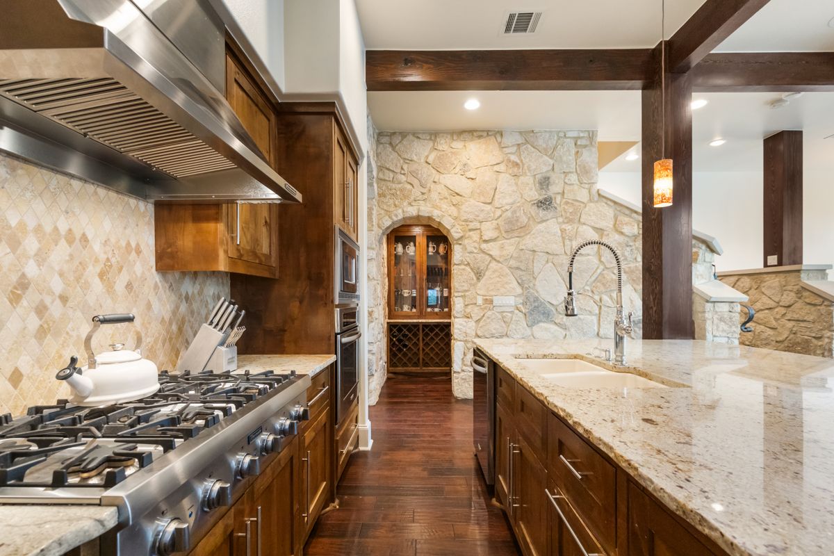 2002 Kinney Avenue, Unit A Austin, TX 78704 - Photo 10 of 26 a kitchen with stainless steel appliances granite countertop a stove and a sink