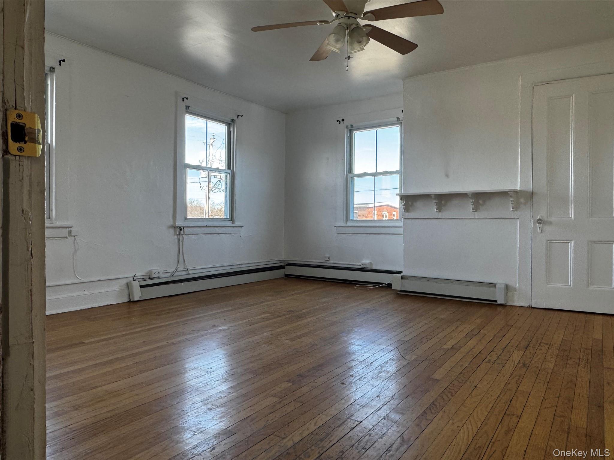 239 West Main Street, Unit 3 Goshen, NY 10924 - Photo 3 of 18 an empty room with wooden floor closet and windows